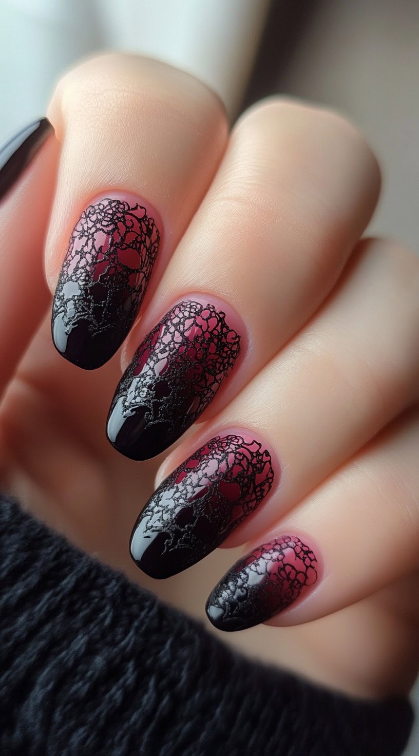 Almond-shaped nails featuring a burgundy-to-black ombre effect with intricate lace detailing for a sultry bridal look.