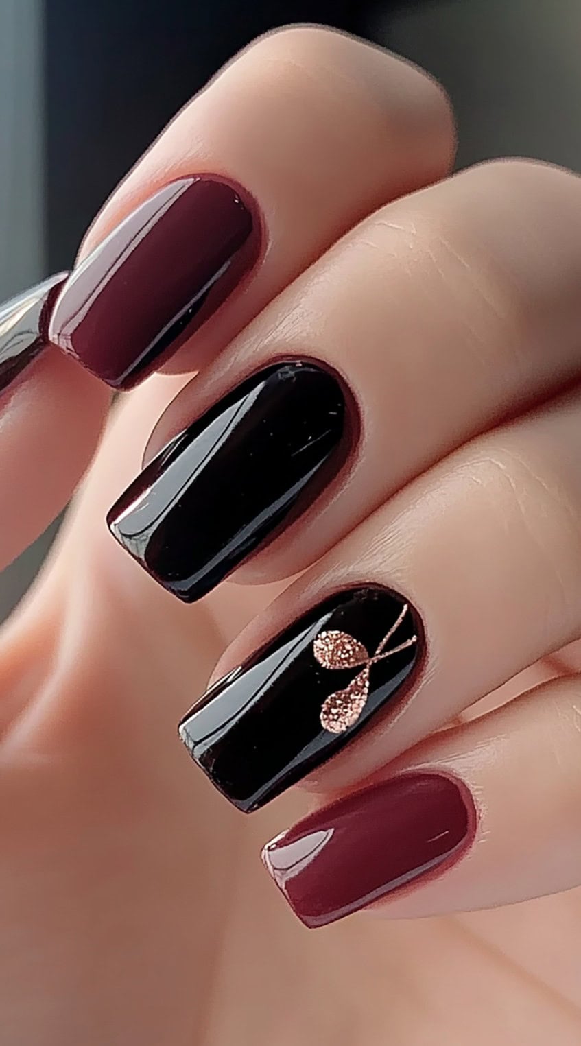 Square-shaped nails featuring alternating burgundy and black polish with a single glitter-accented nail.