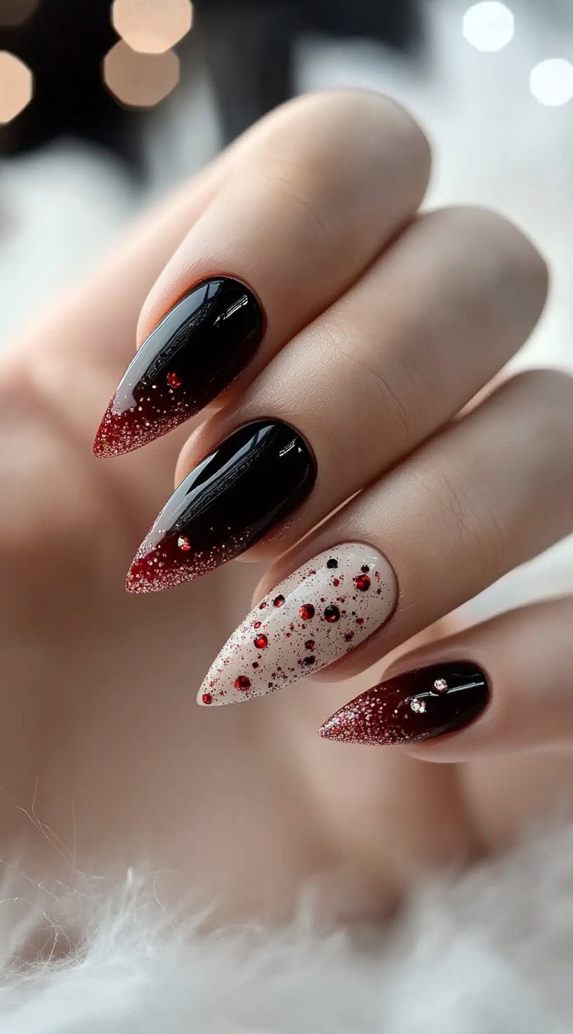 Stiletto nails featuring a mix of glossy burgundy, shimmering white, and red crystal embellishments for a bold, festive finish.