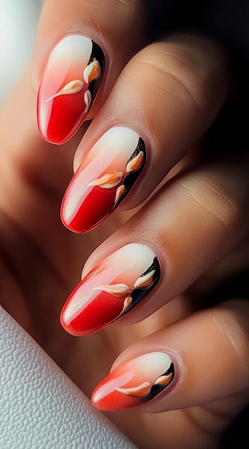 Almond-shaped nails with a coral-to-white ombre base, featuring hand-painted floral designs with black and orange details.