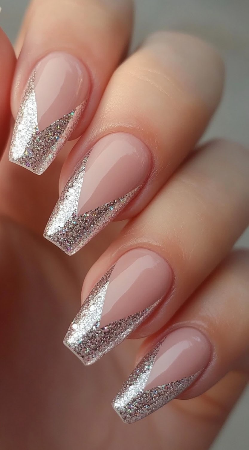 Coffin-shaped nails with a glitter chevron pattern over a nude base.