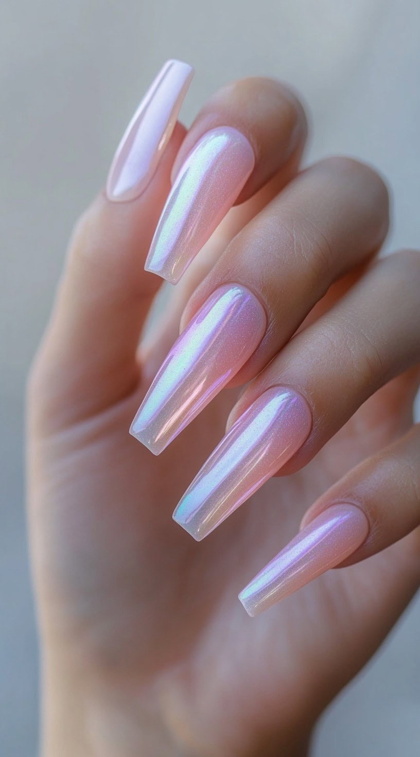 Long, square-shaped nails coated in a pearlescent chrome finish that shifts between pink, lavender, and icy blue hues.
