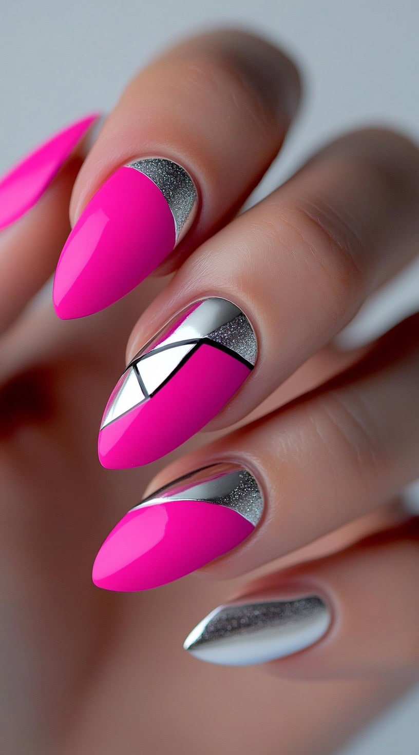 A set of almond-shaped nails featuring a bold hot pink polish, silver geometric accents, and glittery silver cuticles.