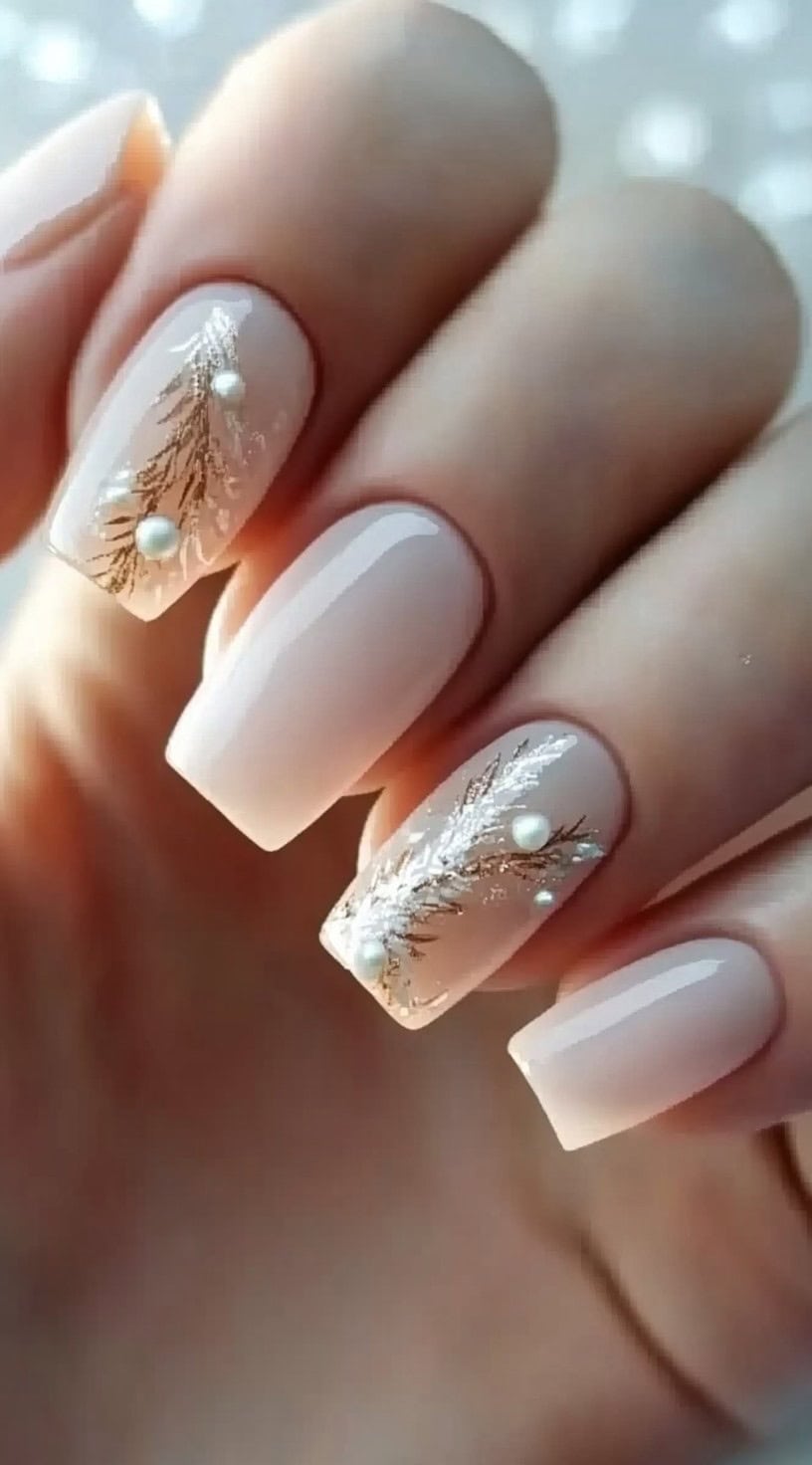 Square-shaped nude nails with gold branch detailing and pearl accents.