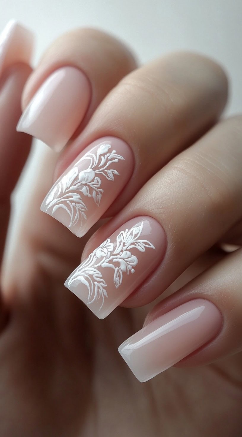 Matte white square nails with intricate embossed floral designs.