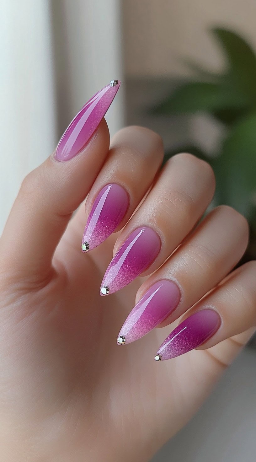 Almond-shaped nails with a pink ombre fade and a single silver rhinestone at the tip of each nail.