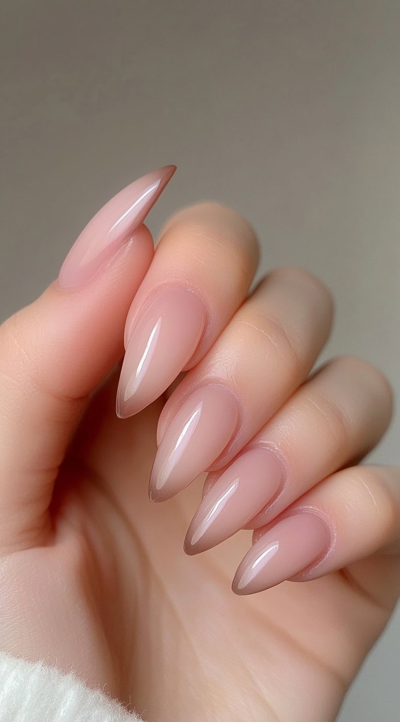 Almond-shaped nails fade from soft pink to brown with a high-gloss natural finish.