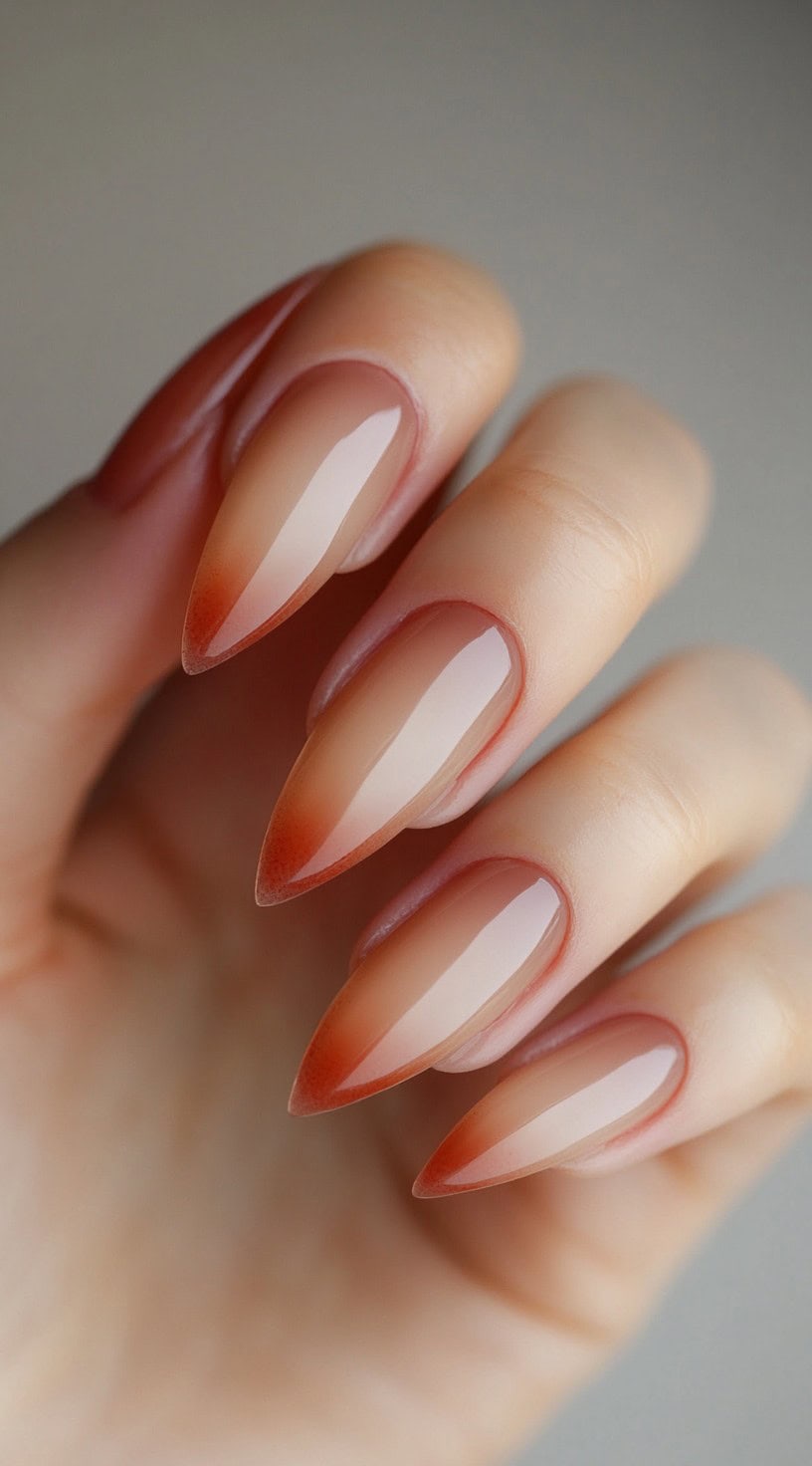 Almond nails with a subtle brown to sheer pink ombre in a barely-there gradient.