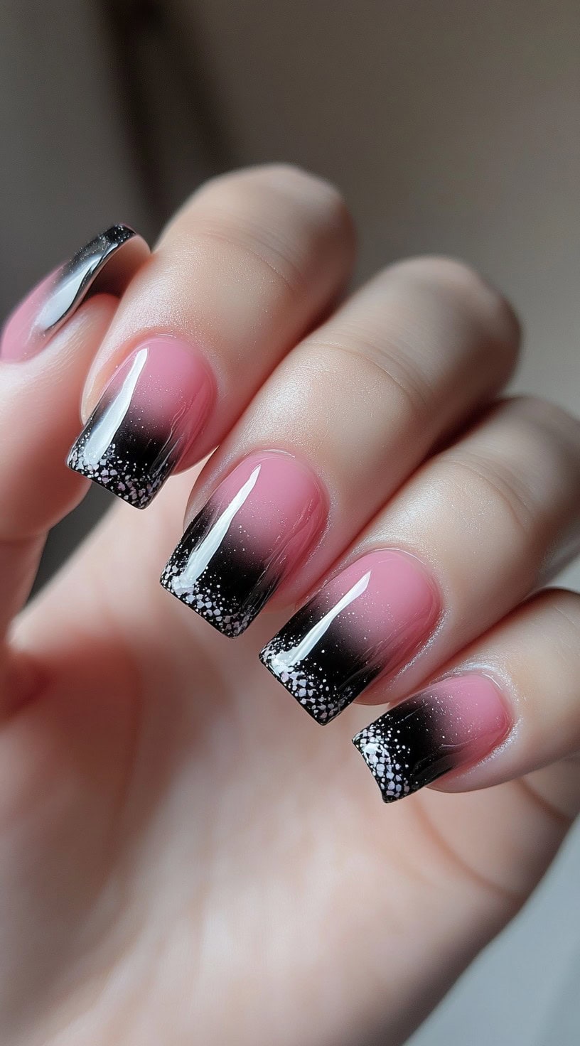 Square-shaped nails with a soft pink-to-black ombre and dense white glitter sprinkled at the tips.