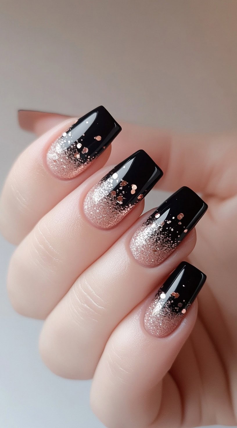 Square-shaped nails with a black and rose gold ombre fade, topped with scattered chunky and fine glitter.