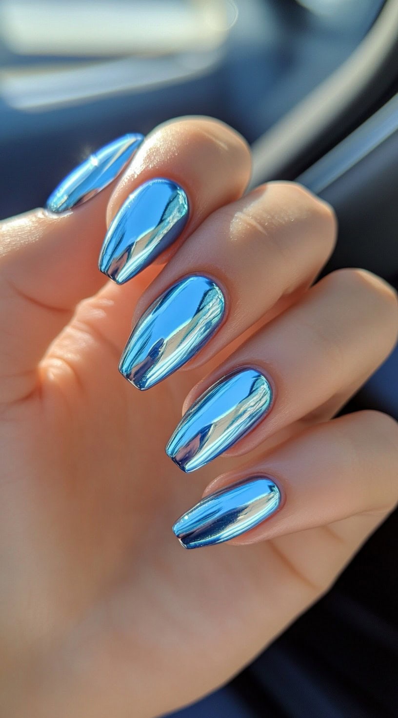 Coffin-shaped nails with a metallic mirror finish in a striking chrome blue.
