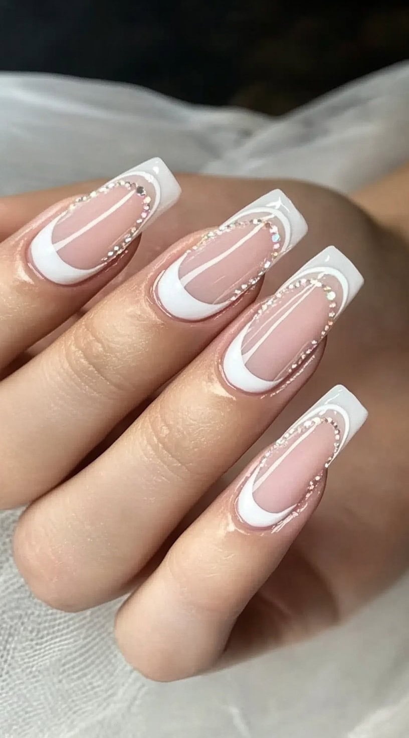 Long square nails with a double French outline, featuring white curved edges and shimmering rhinestone accents.