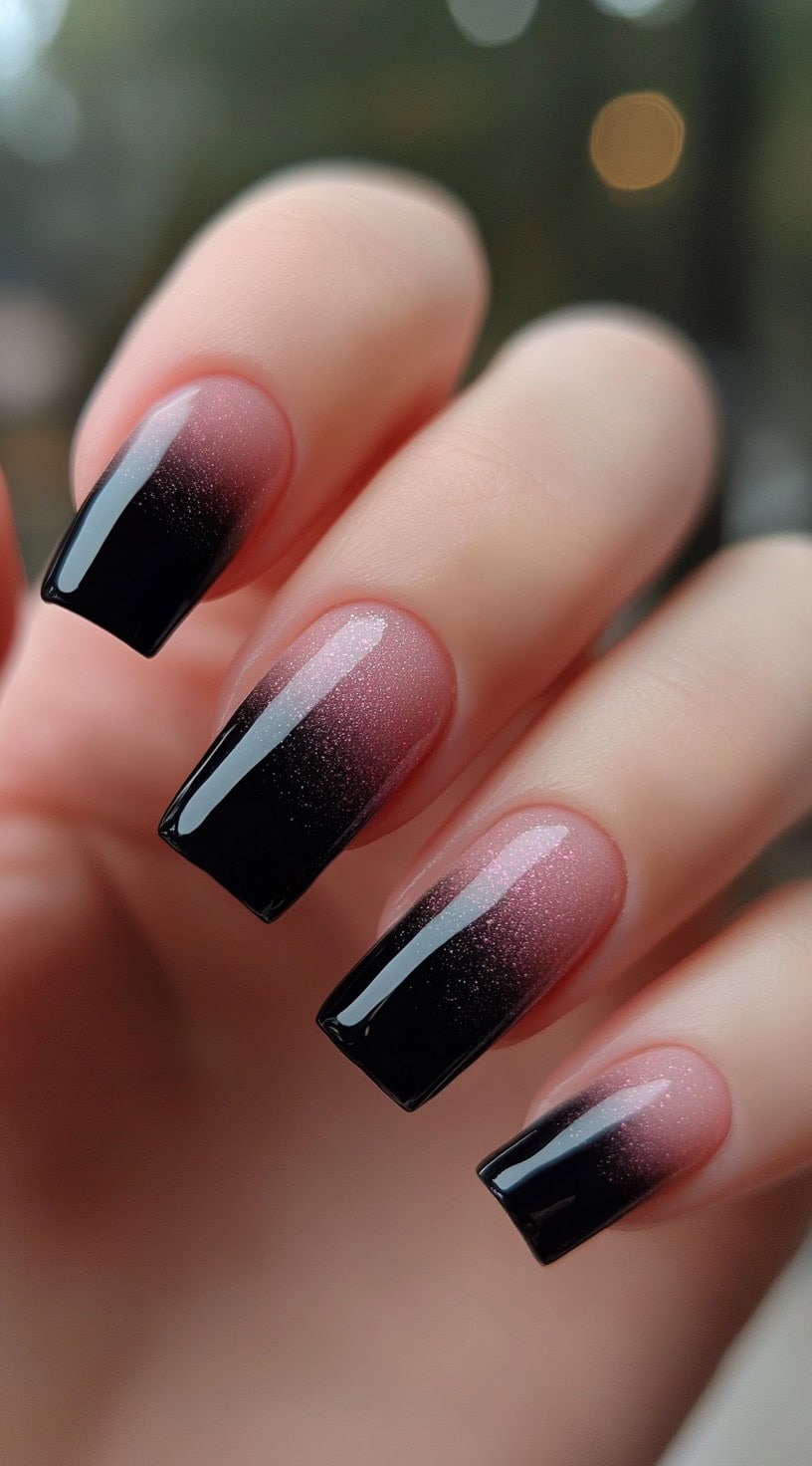 Long square-shaped nails with a glossy pink-to-black ombre fade and fine glitter shimmer.