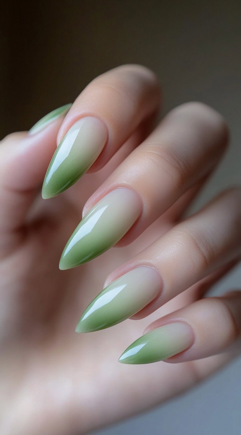 Almond-shaped nails with a seamless gradient ombré blending from natural beige to matcha green tips.