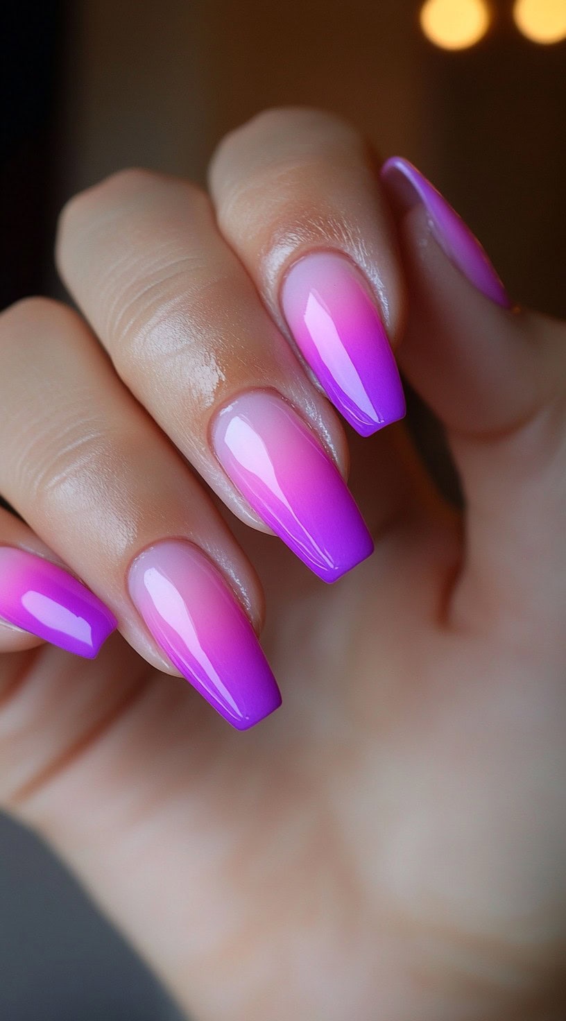 Medium-length coffin nails with a flawless pink to purple ombre gradient and glossy gel finish.
