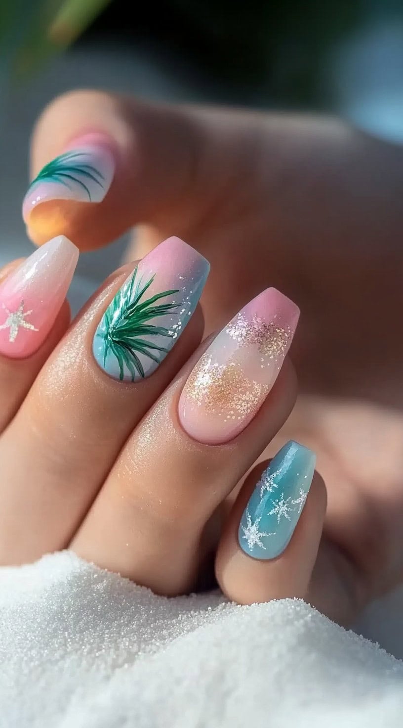 Coffin-shaped nails with ombre pastel shades, palm leaf accents, and glitter details.