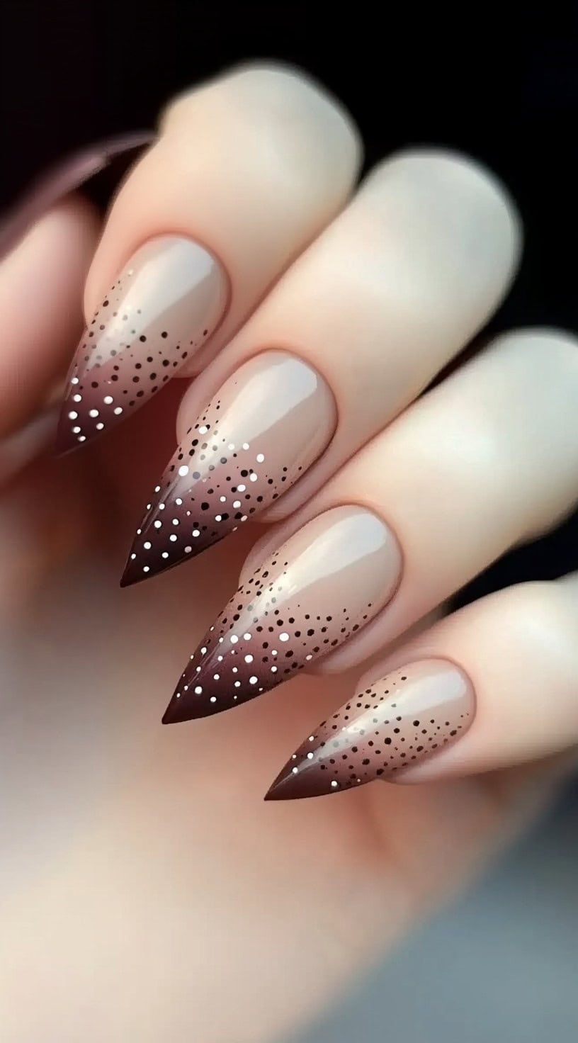 Almond-shaped nails with a gradient of soft pink to brown and dotted accents