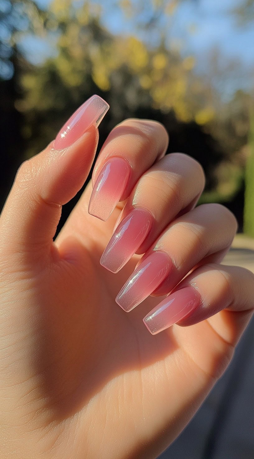 Coffin-shaped nails with a soft rosy pink ombre fade, blending seamlessly from a translucent base.
