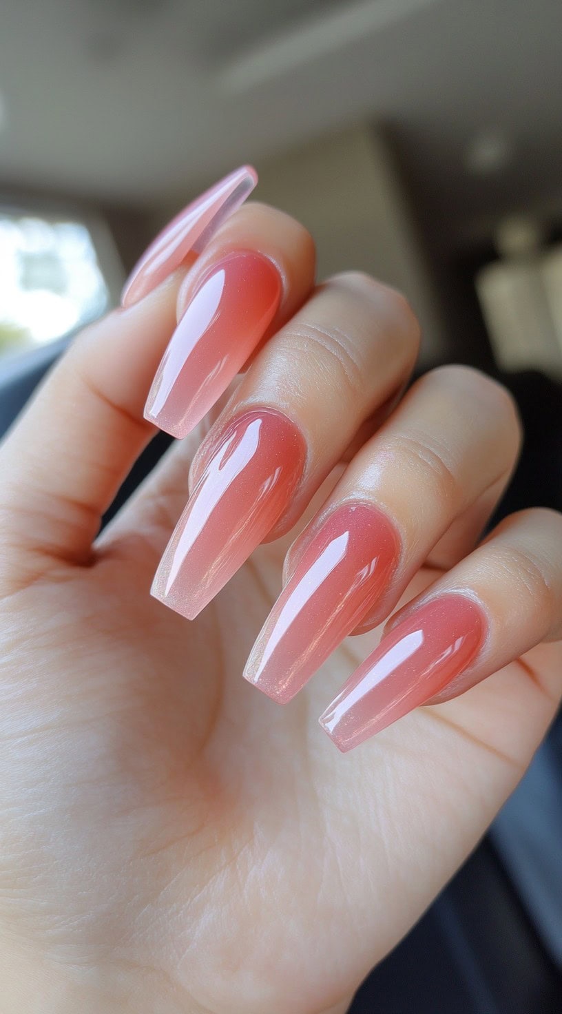Glossy coffin-shaped nails with a soft pink ombre fade from a natural base.