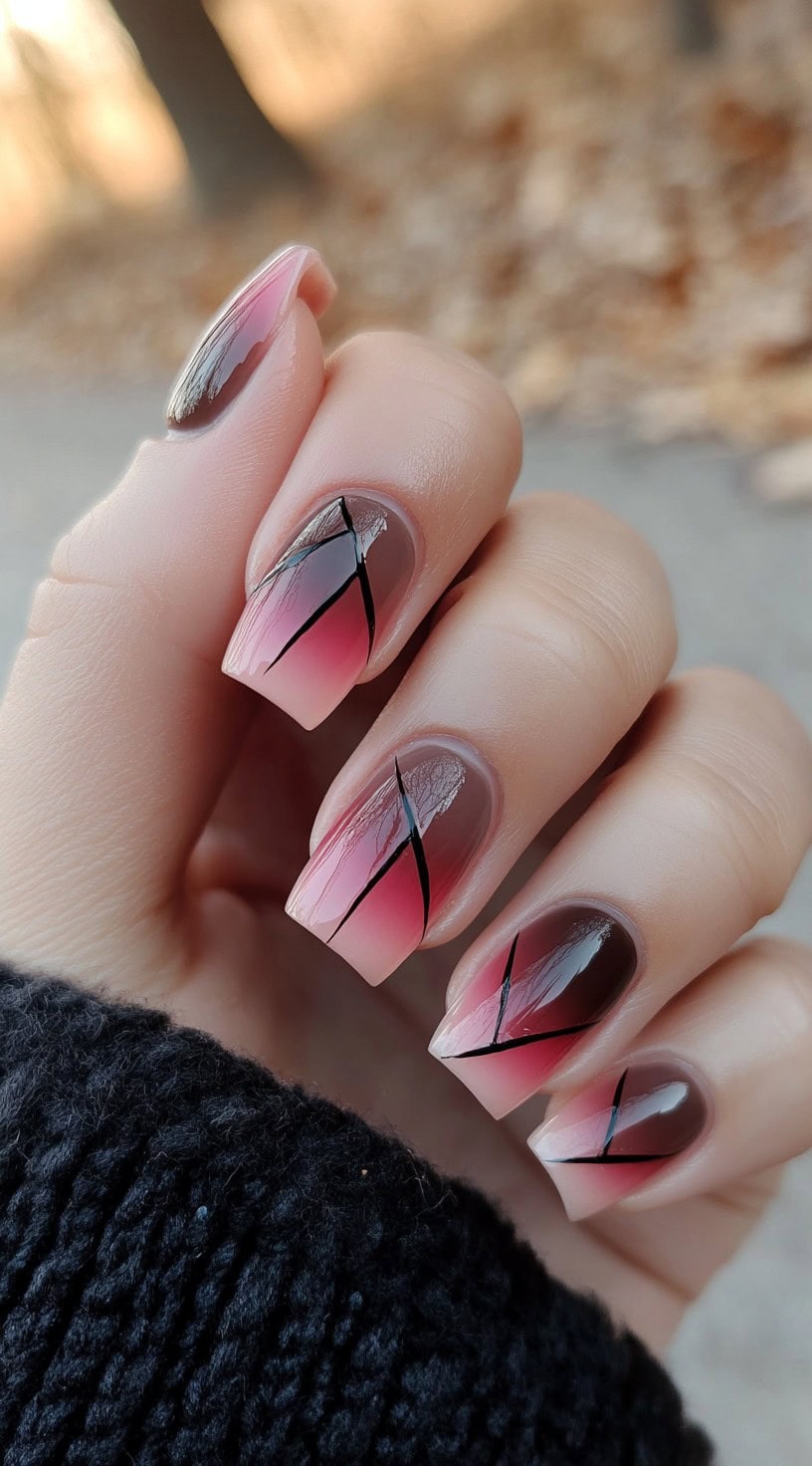 Square-shaped nails feature a pink to brown ombre design accented by thin diagonal black lines.
